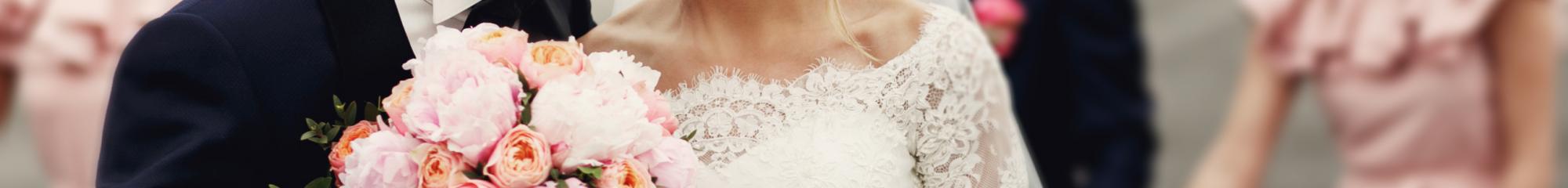 Groom whispering in laughing bride's ear